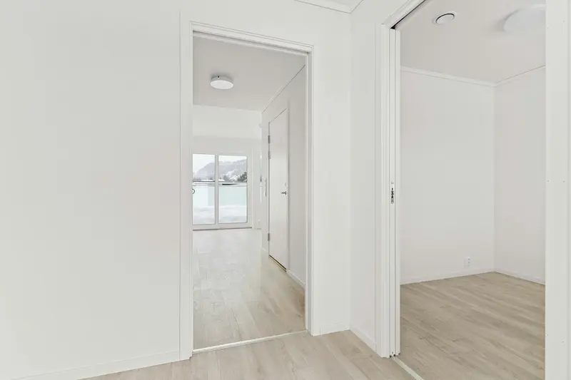 Empty room with white walls and wooden floors, illustrative of a cleared property